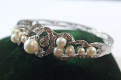 -Antique 14k White Gold Natural Pearl with Diamond Bracelet -Inside diameter: 2.25 in x 1.75 in -Thickness: 4.5 mm ~ 19 mm -Biggest pearl size: 8 mm -Diamond size:about 2 mm -Total weight: 22.5 g -Marked 14k Elegant White Gold Pearl Bracelet For Anniversary, Classic Akoya Pearl Bracelet For Wedding, Wedding Jewelry With Brilliant Cut Akoya Pearls, Brilliant Cut Pearl Wedding Jewelry, Formal Pearl Bracelet, Fine Jewelry Pearl Bracelet For Anniversary, Elegant Hand-set Pearl Jewelry, Akoya Pearl Round Jewelry For Evening, Elegant Akoya Pearl Bracelets For Formal Occasions