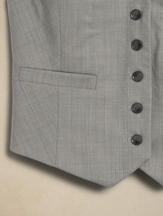 A tailored suit vest, this piece is crafted from our signature Siena Italian wool, selected for its all-weather weight and hint of stretch.  Semi-fitted Fabric sourced from Italy's Marzotto Mill.  V-neck with button-front closure.  Adjustable tabs at waist.  Front pockets.  Fully lined.  Semi-fitted.  Sleeveless.  Above-hip length.  Body length (size S): Regular 21" Model: Size S, 5'10" (178cm). Tailored Suit, Wool Vest, Suit Vest, Siena, Hip Length, Light Gray, Banana Republic, Light Grey, The Selection