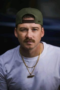 a man with a mustache wearing a hat