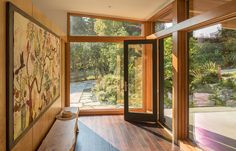 a wooden bench sitting in front of a large window