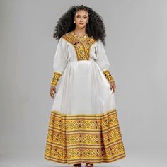 Description Illuminate the room with the golden radiance of our modern Habesha Kemis, adorned with intricate patterns that captivate the eye and celebrate Ethiopian heritage. Crafted with contemporary flair, this dress seamlessly blends tradition with innovation, offering a fresh take on the timeless elegance of Ethiopian attire. The striking golden yellow hue symbolizes prosperity and joy, while the detailed patterns add depth and sophistication to the ensemble. Whether worn for a wedding, cultural event, or any special occasion, this Habesha dress is sure to turn heads and leave a lasting impression. Embrace the spirit of Ethiopian culture with our exquisite golden yellow Habesha Kemis, where tradition meets modernity in perfect harmony. Material Cotton Thread Menen Estimated delivery : Habesha Kemis Ethiopian Dress, Habesha Dress Modern, Ethiopian Clothing, Habesha Dress, Ethiopian Dress, Habesha Kemis, Dress Modern, Scarf Dress, Cultural Events