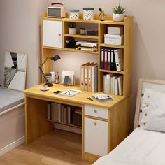 a bedroom with a bed, desk and bookshelf next to it on the wall