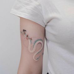 a woman with a snake tattoo on her arm