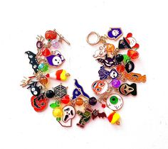 This happy and colorful Halloween charm bracelet is handcrafted by myself and a one of a kind original.  The gold plated chain is 8.25 inches long with 24 drops containing  pumpkins, a jack o lantern,  ghosts, candy corn, bats  and lots and lots of crystals so it sparkles as you move.  It contains an assortment of enamel charms, glass, acrylic and crystals.  If you need it shorter or longer just let me know, and I will adjust it to as close as possible to the size you desire. If you would like a charm switched to something else just ask!  Each charm is placed with thought  for color and balance.  It is  a really fun piece, and sure to make you smile for years to come. If you have any questions, please ask.  I do my best to describe items accurately. If something wouldn't be right it would Handmade Multicolor Bracelets For Halloween, Novelty Multicolor Charm Bracelet, Themed Multicolor Jewelry With Charms, Multicolor Themed Jewelry With Charms, Halloween Novelty Jewelry Bracelet, Halloween Novelty Bracelet, Multicolor Novelty Bracelets For Halloween, Handmade Halloween Novelty Bracelets, Handmade Themed Bracelet For Halloween