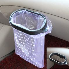 the inside of a car with a plastic trash can and cup holder on it's side