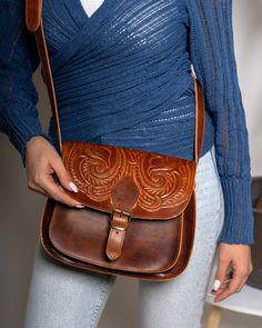 Boho crossbody leather bag, Honey brown pyrography saddle purse, leather shoulder purse, Greek handmade leather tooled bag , manufactured by the best cowleather from our Greek island Crete. This crossbody bag has two different spaces inside big enough for your every day essentials, books, tablet or maybe your mobile. A smaller zipper inside secures a third space which you can put your money or your keys. Inspired by Ancient Greece gives you a unique style that everybody will love. All of our pro Hand-tooled Saddle Bags, Artisan Hand Tooled Crossbody Saddle Bag, Hand Tooled Saddle Bag Satchel For Daily Use, Hand Tooled Saddle Bag For Daily Use, Embossed Leather Crossbody Satchel, Hand Tooled Satchel Saddle Bag For Travel, Brown Engraved Leather Shoulder Bag, Brown Embossed Satchel Shoulder Bag, Brown Leather Engraved Shoulder Bag