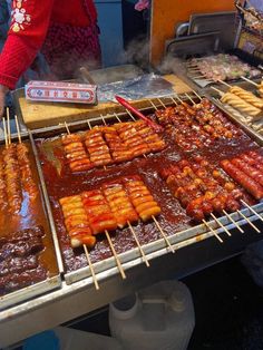 the food is being prepared and cooked on the grill at the street vendor's stall