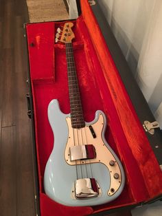 a blue and white guitar in a red case