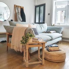 a living room filled with furniture and a mirror