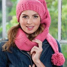 a woman wearing a pink hat and scarf