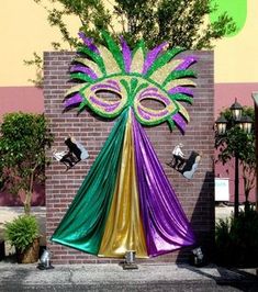 a mardi gras decoration on the side of a building