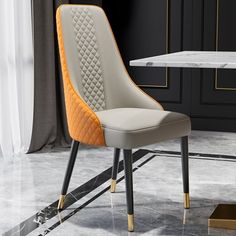 a white and gold chair sitting in front of a table with a marble slab on the floor