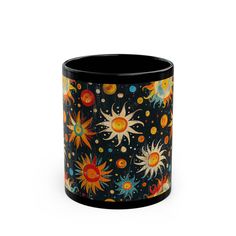 a black mug with sun and stars on it