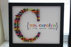 there is a frame made out of crayons and the words ms carolyn on it