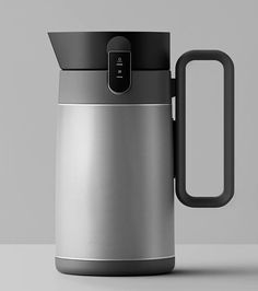 a stainless steel coffee pot with a black handle