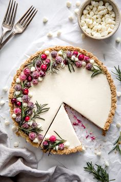 a cheesecake topped with cranberries and marshmallows on a table