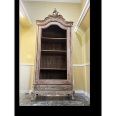 an old fashioned bookcase in the corner of a room