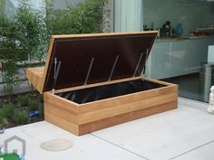 an open wooden box sitting on top of a patio