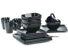 a set of black cups and saucers sitting on top of each other