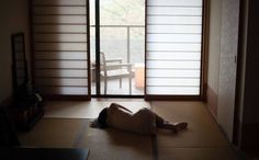 a person laying on the floor in front of a sliding glass door