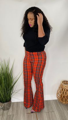 High Waist Bell Bottom Pants with pockets and button front in a red plaid print. Model is wearing a size Small High waist bell bottom red plaid Red Checkered, Checkered Print, Pants With Pockets, Bell Bottom Pants, Bell Bottom, Plaid Print, Red Plaid, Bell Bottoms, Capri Pants