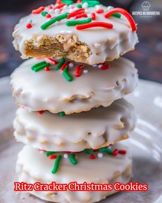 three christmas cookies stacked on top of each other with white frosting and sprinkles