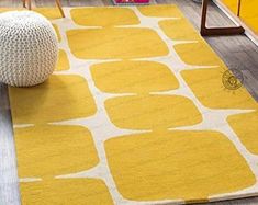 a yellow and white rug in a living room