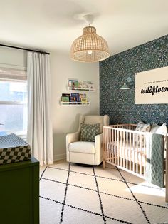 a baby's room with a crib, rocking chair and wallpaper on the walls