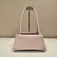 SHOP MORE LUXURY PRODUCTS HERE Description Prada Small Bag Pink For Women, Women’s Bags 9.8in/25cm A study of the lines characterizes this smallÃƒÂ¯Ã‚Â¿Ã‚Â½ÃƒÂ¯Ã‚Â¿Ã‚Â½ÃƒÂ¯Ã‚Â¿Ã‚Â½ÃƒÂ¯Ã‚Â¿Ã‚Â½ handbag. It stands out for its absolutely elegant silhouette emphasized by the long, narrow handle. This three-pocket accessory is decorated with the metal lettering logo. Size: 25 x 13.5 x 13 cm /9.8 x 5.3 x 5 inches (Length x Width x Height) PinkHandlesMetal hardwarePrinted lettering logo on the fr Prada Small Bag, Pink Handles, Metal Lettering, Louis Vuitton Shirt, Chanel Shirt, Gucci Gg Marmont, Lettering Logo, Small Handbag, Metal Letters