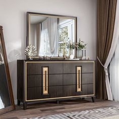 a large mirror sitting on top of a wooden dresser next to a window with curtains