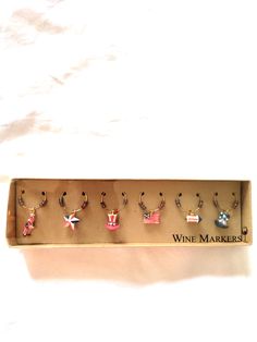 a wine box with six different earrings in it