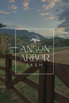 the logo for an outdoor farm with mountains in the background and a wooden fence that says,