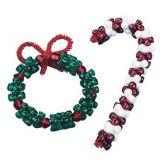 two christmas bracelets with bows and bells attached to each other on a white background