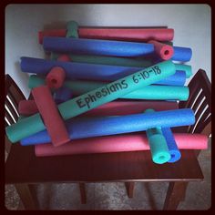 a bunch of different colored yoga mats sitting on top of a wooden table