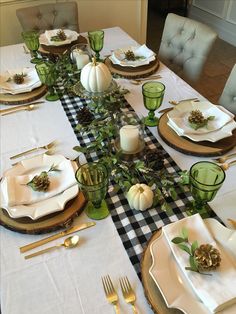 the table is set with place settings for dinner