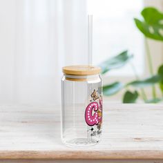 a glass jar with a straw in it on a table