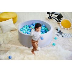 Jump for joy! This ball pit brings hour after hour of active fun right into the playroom. A gift that's sure to wow little ones, it's perfect for getting out all that energy at home. The set comes with polyethylene balls in cool colors, plus a grey ball pit great for gender neutral kids rooms and play spaces. The pit is made from heathered cotton jersey spandex and foam for a sturdy yet portable design, allowing you to easily move the good times from room to room.  • Kids ball pit set for active Neutral Kids Rooms, Gender Neutral Kids Room, Kids Ball Pit, Neutral Kids Room, Jump For Joy, Ball Pool, Play Spaces, Blue Ball, Jumping For Joy