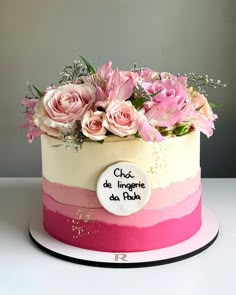 a cake decorated with pink and white flowers on a plate that says chix de impagie de fushi