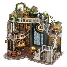 a doll house with stairs and lots of furniture