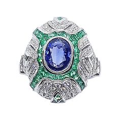 Blue Sapphire 1.49 carats with Emerald 2.44 carats and Diamond 0.48 carat Ring set in 18 Karat White Gold Settings Width: 0.7 cm Length: 0.9 cm Ring Size: 51 Total Weight: 8.3 grams "We first opened doors in 1980 when it was then situated in the vicinity of the Victory Monument; a small and modest storefront with a couple of counters. From its humble beginnings to where it stands today, our company has proven its abilities as a jeweler. Since the beginning, we have been supplying fine quality pi Diamond Cuff Ring, Emerald And Diamond Ring, Diamond Ring Set, Emerald Diamond Ring, Retro Ring, White Gold Set, White Diamond Ring, Diamond Ring Settings, Gold Ring Sets