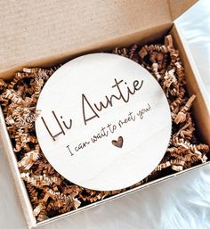 a box that has some pine cones in it with the words lil autie on it