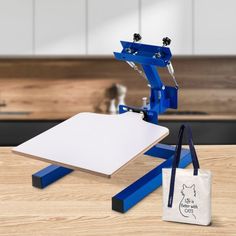 a white board sitting on top of a wooden table next to a blue and white bag