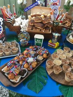 a table topped with lots of desserts and pastries