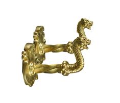 a gold brooch with two lions on it