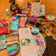 the contents of a purse are laid out on the floor next to some candy and other items