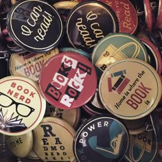 many different colored and black buttons with words on them, all in various shapes and sizes