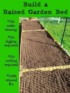 a garden bed with dirt growing in it and the words build a raised garden bed below