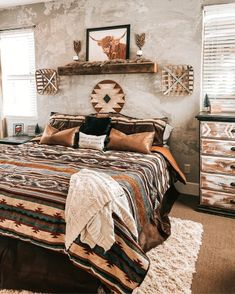 a bedroom with a bed, dressers and pictures on the wall above it's headboard