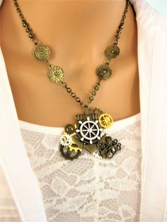 I created this assemblage style Steampunk necklace with a large brass anchor charm, a silver metal ship wheel charm, a brass octopus charm, and multi colored steampunk gears. Unique handmade necklace for women or men, unisex jewelry. The necklace chain is brass antique gold metal. There are 4 round brass stamped metal links on the chain, and large detailed brass links. The necklace is 18 inches, and has a lobster clasp. The pendant is about 2 inches tall by 2 inches wide. This necklace, and coul Handmade Steampunk Metal Necklace, Steampunk Metal Necklaces For Festivals, Steampunk Metal Necklace For Festivals, Handmade Steampunk Jewelry For Festivals, Octopus Necklace, Assemblage Necklace, Style Steampunk, Anchor Charm, Steampunk Gears