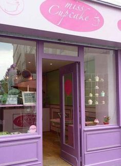 a purple store front with the door open